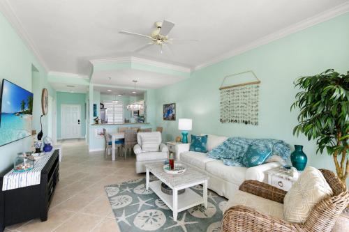 a living room with a couch and a table at Spacious Condo - 2 King Suites - Close to Beaches in Marco Island