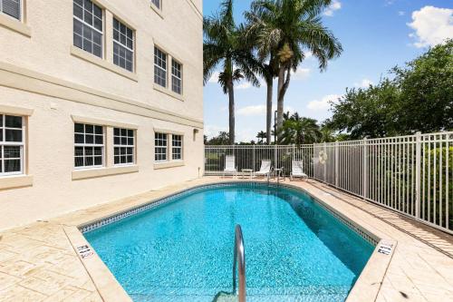 a swimming pool in front of a building at Spacious Condo - 2 King Suites - Close to Beaches in Marco Island