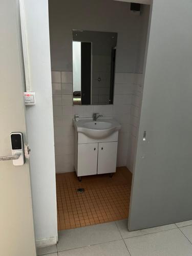 a bathroom with a sink and a mirror at Yatulau Hotel and Conference in Suva