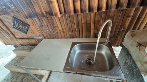 a metal sink with a faucet in a bathroom at Rendan Kubo in Batangas City
