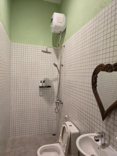 a bathroom with a toilet and a sink at Laguna Ijen Homestay in Banyuwangi