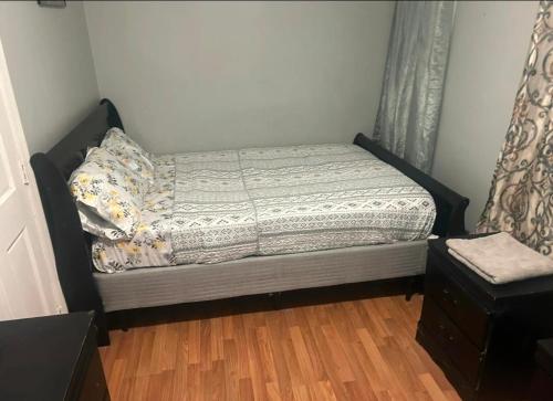 a small bed in a room with a window at Grove 4- Queen bed with Private bathroom in Irvington