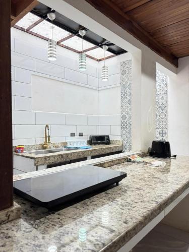 a kitchen with a counter with a sink and a counter sidx sidx sidx at Casa Gavril Escazu in San Antonio