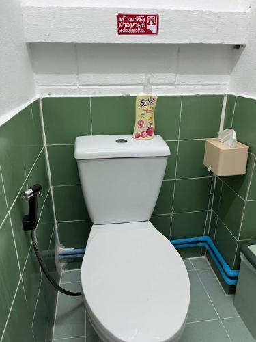 a bathroom with a toilet with a sign above it at SDD HoSTEL in Thung Si Kan