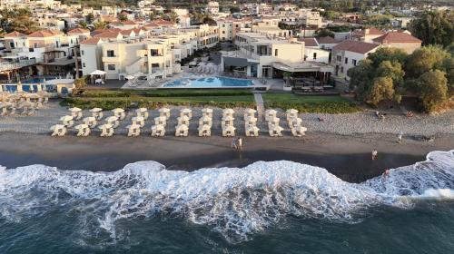 an aerial view of a beach with chairs and the ocean at Blue Dome Hotel in Platanias