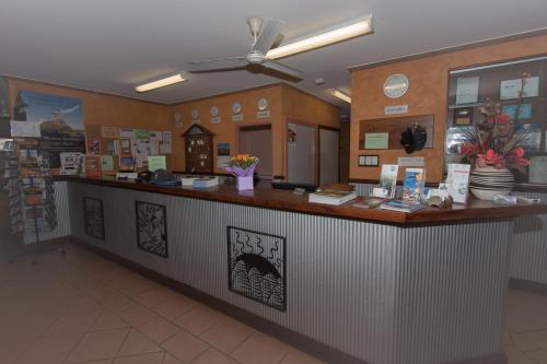 a restaurant with a counter in a store at Ivanhoe Resort in Kununurra