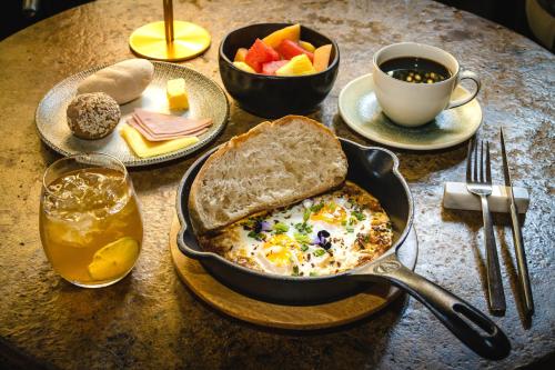 a table with a breakfast of eggs and toast and a cup of coffee at Cinco Quintas Hotel Boutique in Cartagena de Indias
