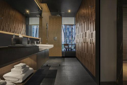 a bathroom with a sink and a counter with towels at Discovery SCBD Jakarta in Jakarta