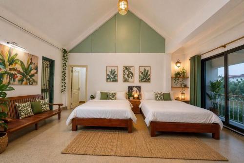 a bedroom with two beds and a large window at Orchid Villa in Kỳ Vĩ