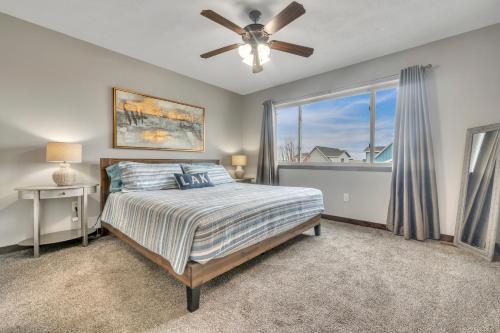 a bedroom with a bed and a ceiling fan at Poolside Retreat at Bridges Bay in Arnolds Park