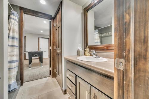 a bathroom with a sink and a mirror at Poolside Retreat at Bridges Bay in Arnolds Park