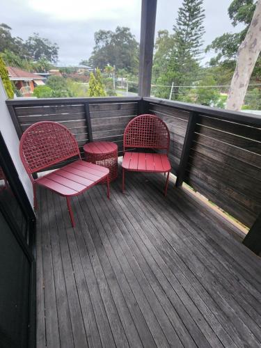 two chairs sitting on a deck with a view at Saltwater Daze - Hosted in Sunshine Bay
