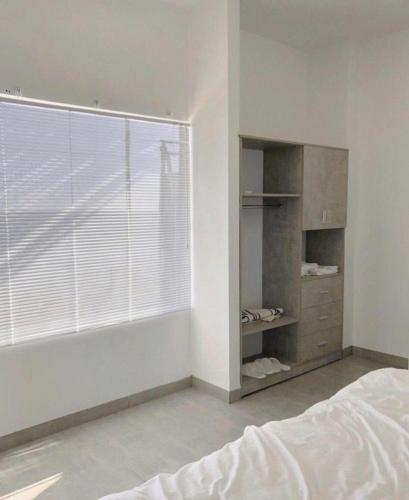 a bedroom with a bed and a large window at 3B MAISON Homestay & Villa in Mui Ne