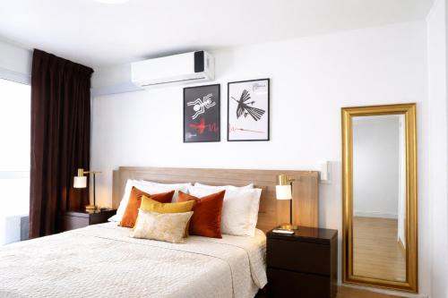 a bedroom with a large bed and a mirror at Miraflores Nest Upper Pardo in Lima