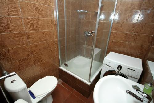 a bathroom with a shower and a toilet and a sink at Pechersk Apartment in Kiev Center in Kyiv