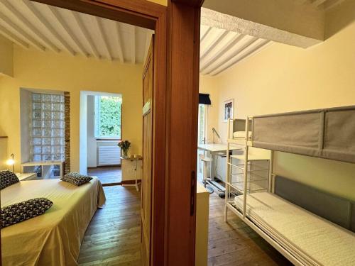 a bedroom with a bunk bed and a bathroom at Charming Mansion in Lucca in Lucca