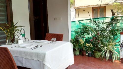 a table in a restaurant with a white table cloth at Marari Umapathi Beach Villa in Mararikulam