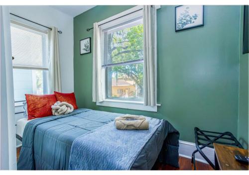 a bedroom with a bed and a window at Spacious Home Near Starland, River St & DT - Arcade in Savannah