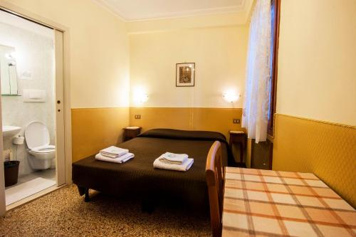 En eller flere senger på et rom på Hotel Locanda Ca' Foscari