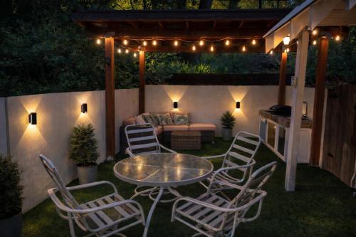 a patio with a table and chairs at night at Dunsmuir Getaway in Dunsmuir