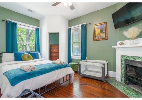 a bedroom with a bed and a fireplace at Spacious Home Near Starland, River St & DT - Arcade in Savannah