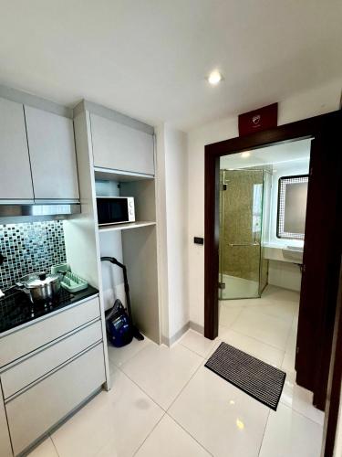 a small kitchen with a sink and a stove at Apartment Serenity Wongamat in North Pattaya