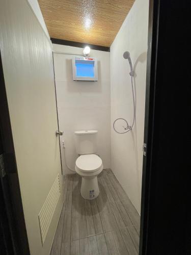 a small bathroom with a toilet and a window at Lamai Home 2 in Ko Yao Noi