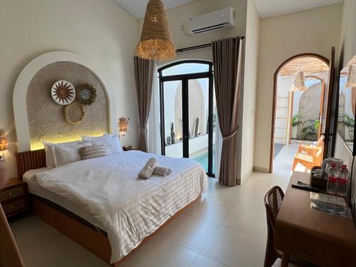 a bedroom with a bed and a large window at Numar Villas Yogyakarta in Seturan