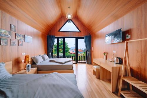 a bedroom with two beds and a window at Cat Ba Spring Homestay in Cat Ba