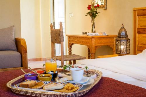 a tray of food on a table in a room at Riad Sougtani in Marrakech