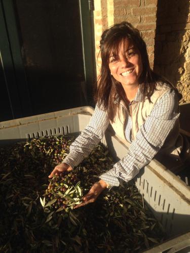 a woman standing in a container filled with greens at Agriturismo Il Macchione in Pienza