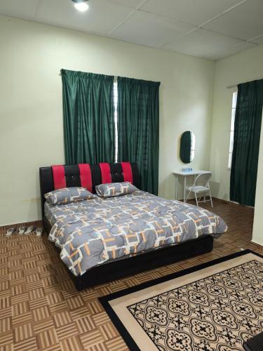 a bedroom with a bed with a red head board at Dsurau Homestay in Kota Bharu