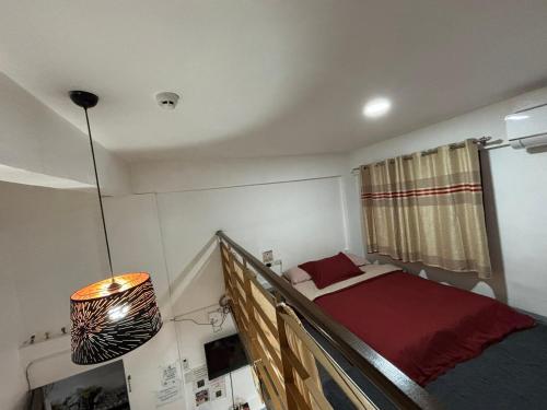 a small bedroom with a bed and a window at Apartment MJ in Olongapo
