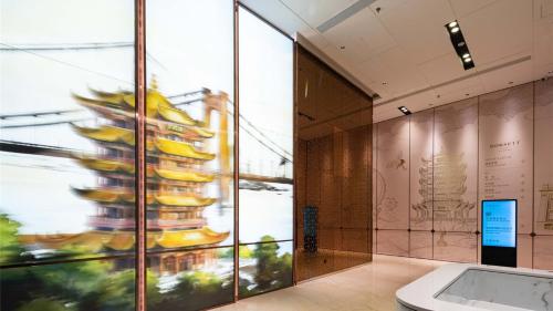 a lobby of a building with a sign on the wall at Dorsett Wuhan in Wuhan