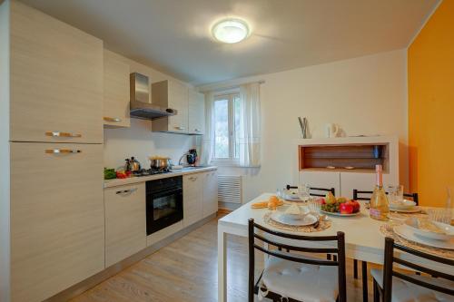 a kitchen with a table with chairs and a counter top at Torbole Lake Front - Happy Rentals in Arco