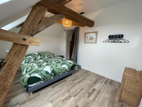 a bedroom with a bed and a wooden floor at Résidence Les Cépages in Saint-Jean-de-Vaux