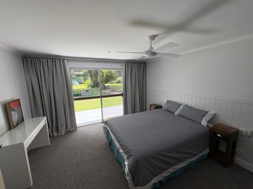 a bedroom with a bed and a large window at Cowan Lodge in Cowan Cowan