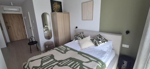 a bedroom with a bed with pillows on it at Pino 34 Sobieszewo in Gdańsk