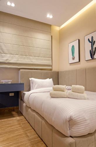 a bedroom with a large bed with towels on it at La Mirada New Cairo in Cairo