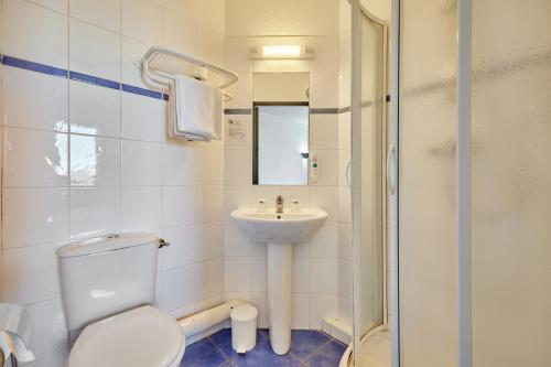 a bathroom with a toilet and a sink at CIT'HOTEL Armony Hotel in Bourg-Achard
