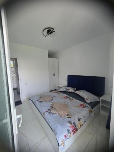 a bed with a blue headboard in a room at Casa Matei Gabriel in 2 Mai