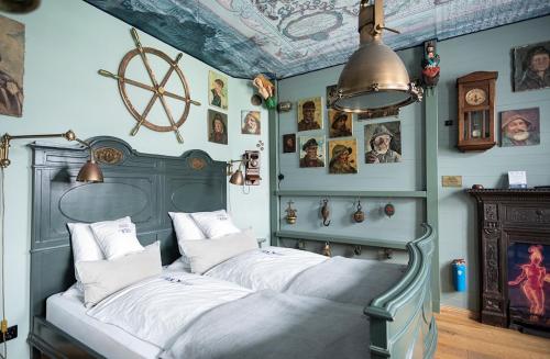 a bedroom with two beds and pictures on the walls at Boutique Hotel Haus Noge in Westerland