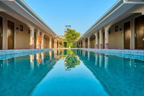 a swimming pool with blue water in a building at BARA BARA' Budget SATUN 'SHA Plus' in Satun