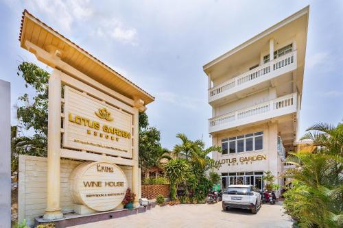a building with a truck parked in front of it at Sunday Lotus Garden Resort By The Sea Mui Ne in Mui Ne