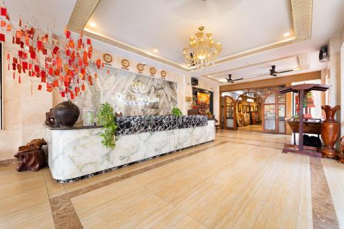 a lobby with a reception desk in a building at Sunday Lotus Garden Resort By The Sea Mui Ne in Mui Ne