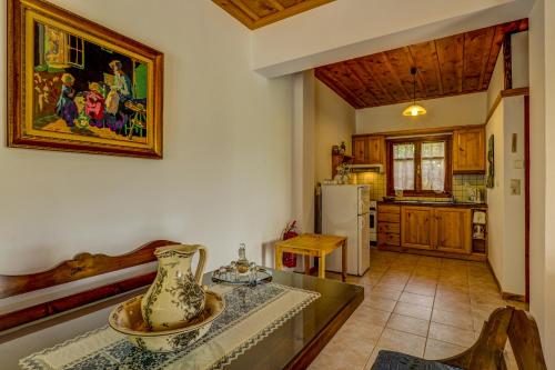 a kitchen with a table with a vase on it at Manoli's House in Douliana