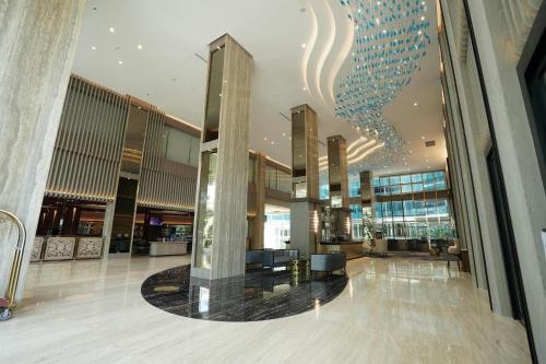 a lobby of a building with a chandelier at Wyndham Panbil Batam in Batam Center