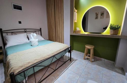a bedroom with a bed with a mirror and a stool at Olive Groove Chios in Chios
