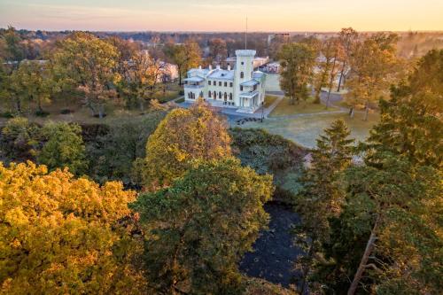 an aerial view of a white house in the woods at Schloss Fall, Keila-Joa in Keila-Joa
