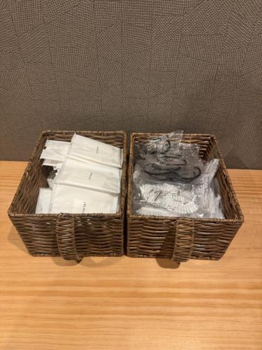 two baskets sitting on top of a wooden table at Ruka Hotel Tennoji in Osaka